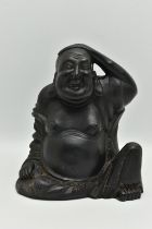 A MODERN BLACK RESIN FIGURE OF A SEATED BUDDHA, posed with one hand on his head, height 22cm (