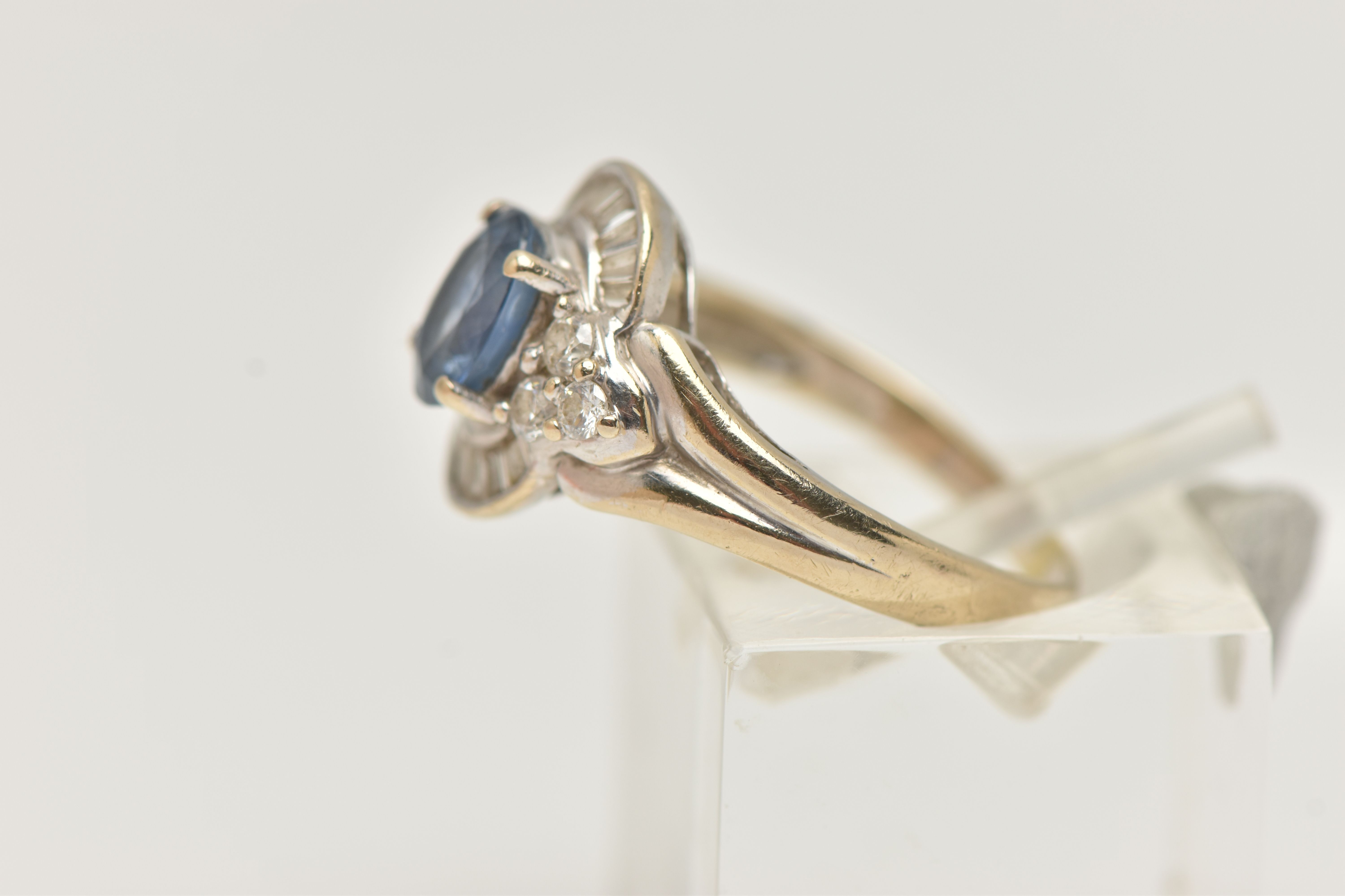 A WHITE METAL SAPPHIRE AND DIAMOND RING, set with an oval cut sapphire, measuring approximately 7. - Image 2 of 4