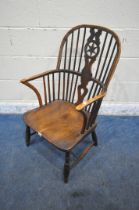 A 19TH CENTURY ELM WINDSOR ARMCHAIR, with spindle back, the central splat with a star detail, shaped