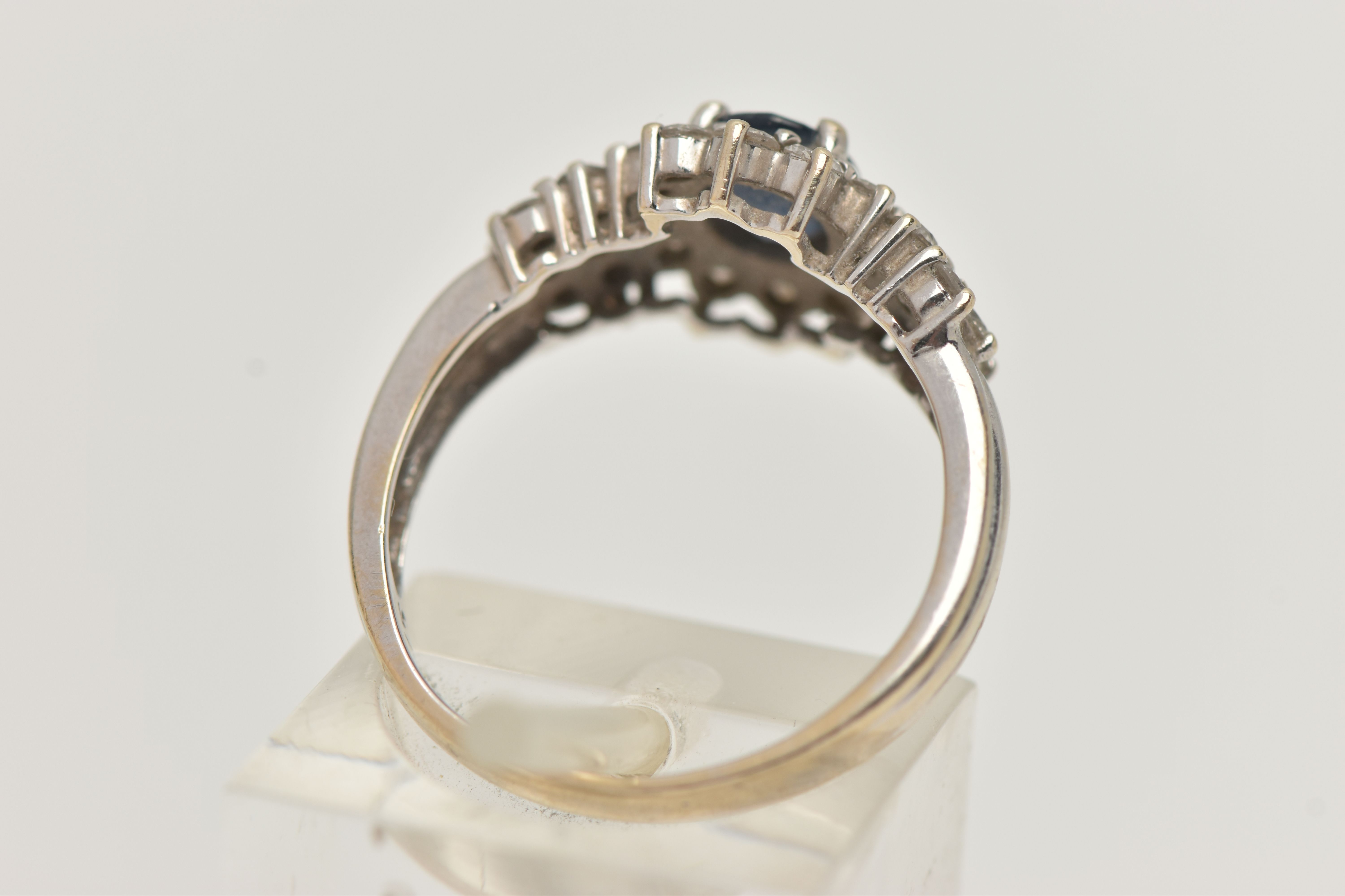 AN 18CT WHITE GOLD SAPPHIRE AND DIAMOND CLUSTER RING, centrally set with an oval cut blue - Image 3 of 4
