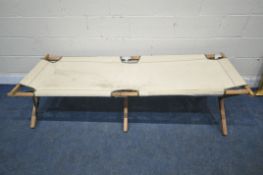 A 20TH CENTURY FOLDING CAMPAIGN STYLE BED, length 195cm (condition report: slightly tear to