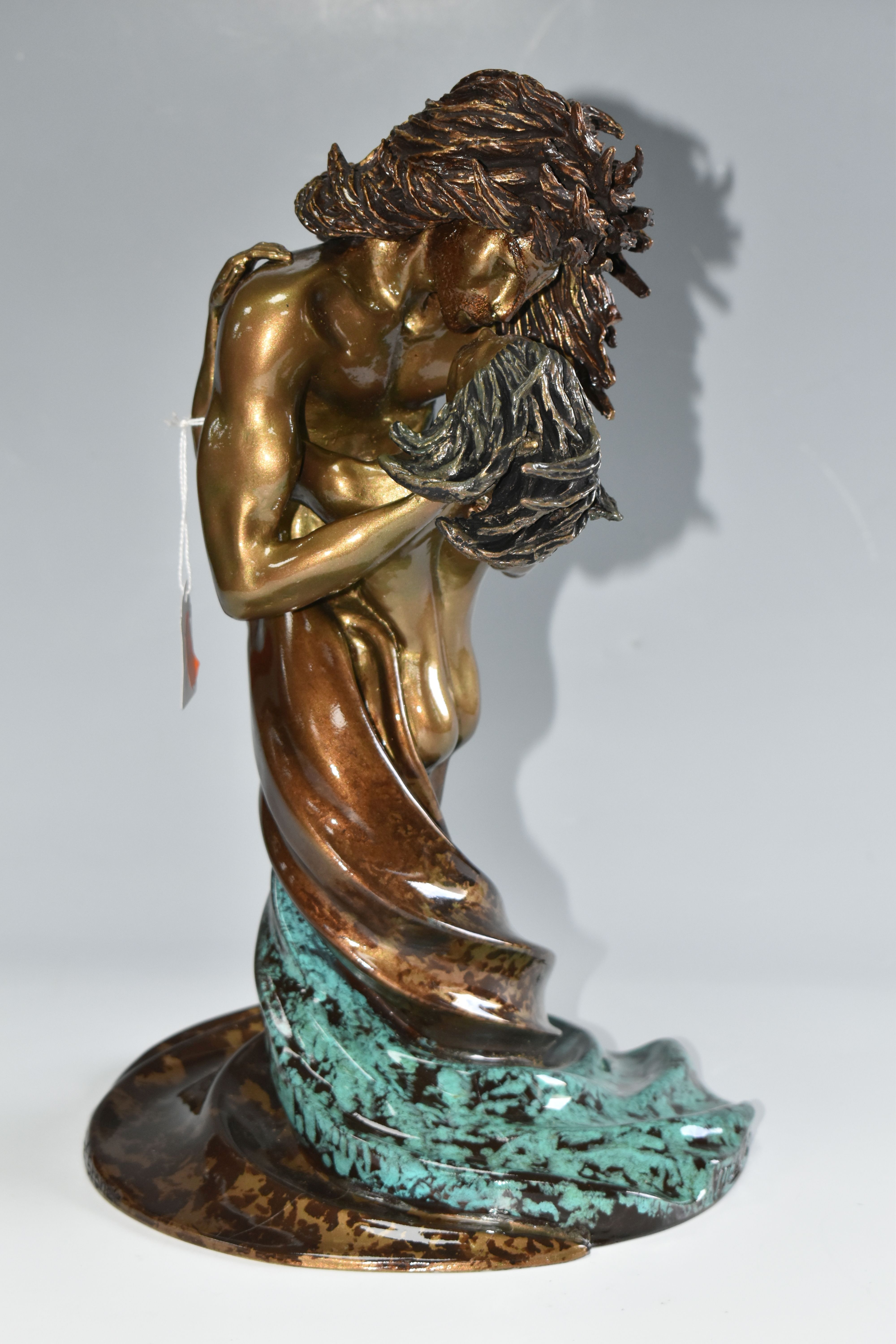 A LIMITED EDITION BONDED BRONZE OR BRONZED RESIN SCULPTURE, depicting two figures in an embrace,