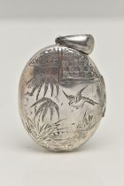 A VICTORIAN SILVER LOCKET, oval form locket with etch detail of palm trees and swallows, fitted with