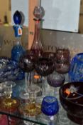 A GROUP OF COLOURED CUT CRYSTAL, to include six cranberry coloured wine glasses, decanter (damaged