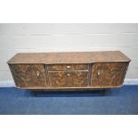 A MID CENTURY VENEERED SIDEBOARD, fitted with two cupboard doors, a single drawer and a fall front