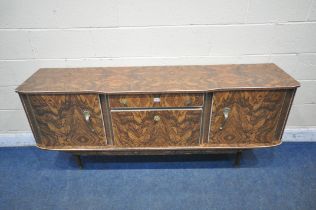 A MID CENTURY VENEERED SIDEBOARD, fitted with two cupboard doors, a single drawer and a fall front