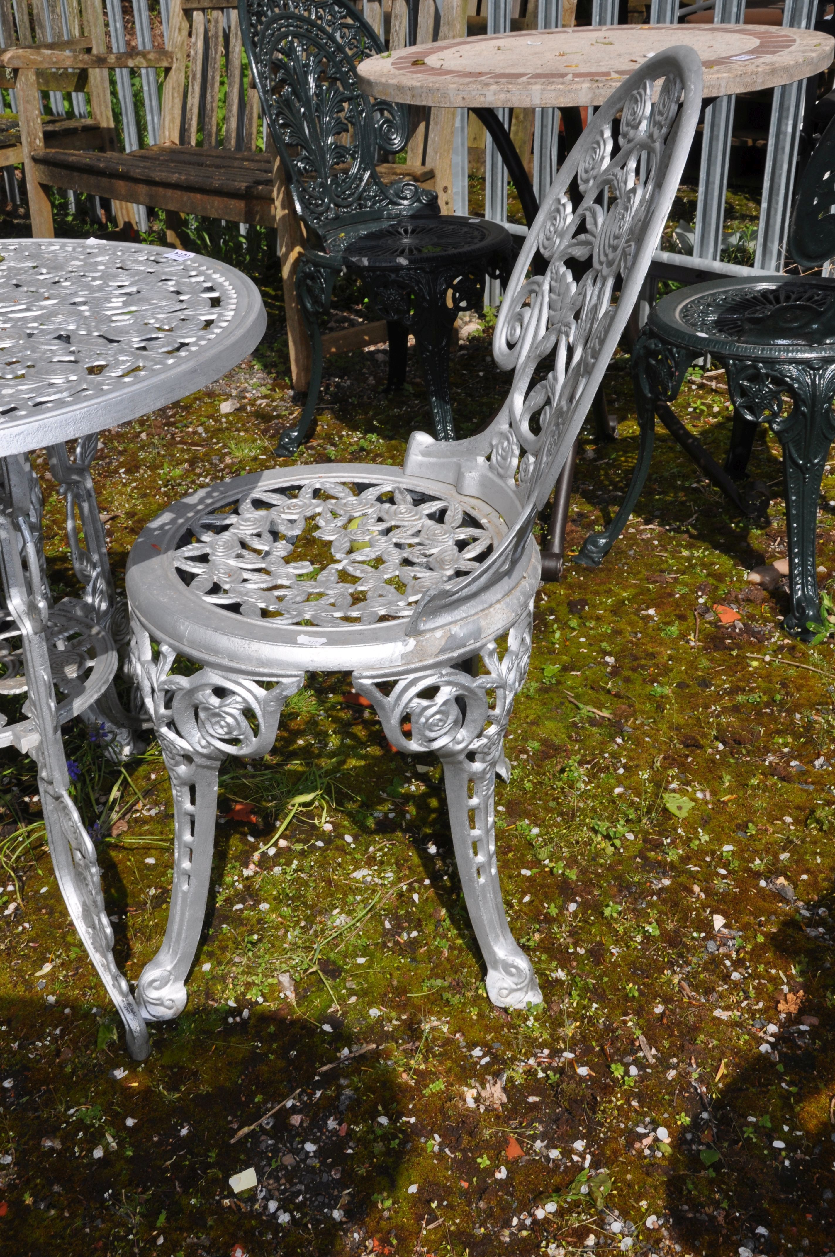 A SILVER PAINTED CAST ALUMINIUM GARDEN TABLE AND A PAIR OF MATCHING CHAIRS with pierced foliate - Image 3 of 3