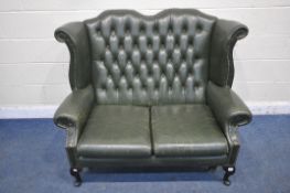 A QUEEN ANNE STYLE GREEN LEATHER UPHOLSTERED WINGBACK TWO SEATER SOFA, length 132cm x depth 88cm x