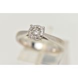 A WHITE METAL DIAMOND CLUSTER RING, centrally set with a round brilliant cut diamond, in a