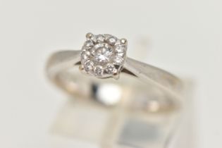 A WHITE METAL DIAMOND CLUSTER RING, centrally set with a round brilliant cut diamond, in a