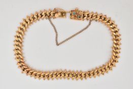 A FANCY LINK BRACELET, the curb link bracelet with beaded floral detail to the central links and