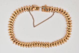 A FANCY LINK BRACELET, the curb link bracelet with beaded floral detail to the central links and