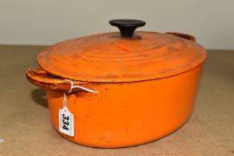 A LE CREUSET LIDDED CASSEROLE DISH, oval shaped, size 27, orange colourway (1) (Condition Report: