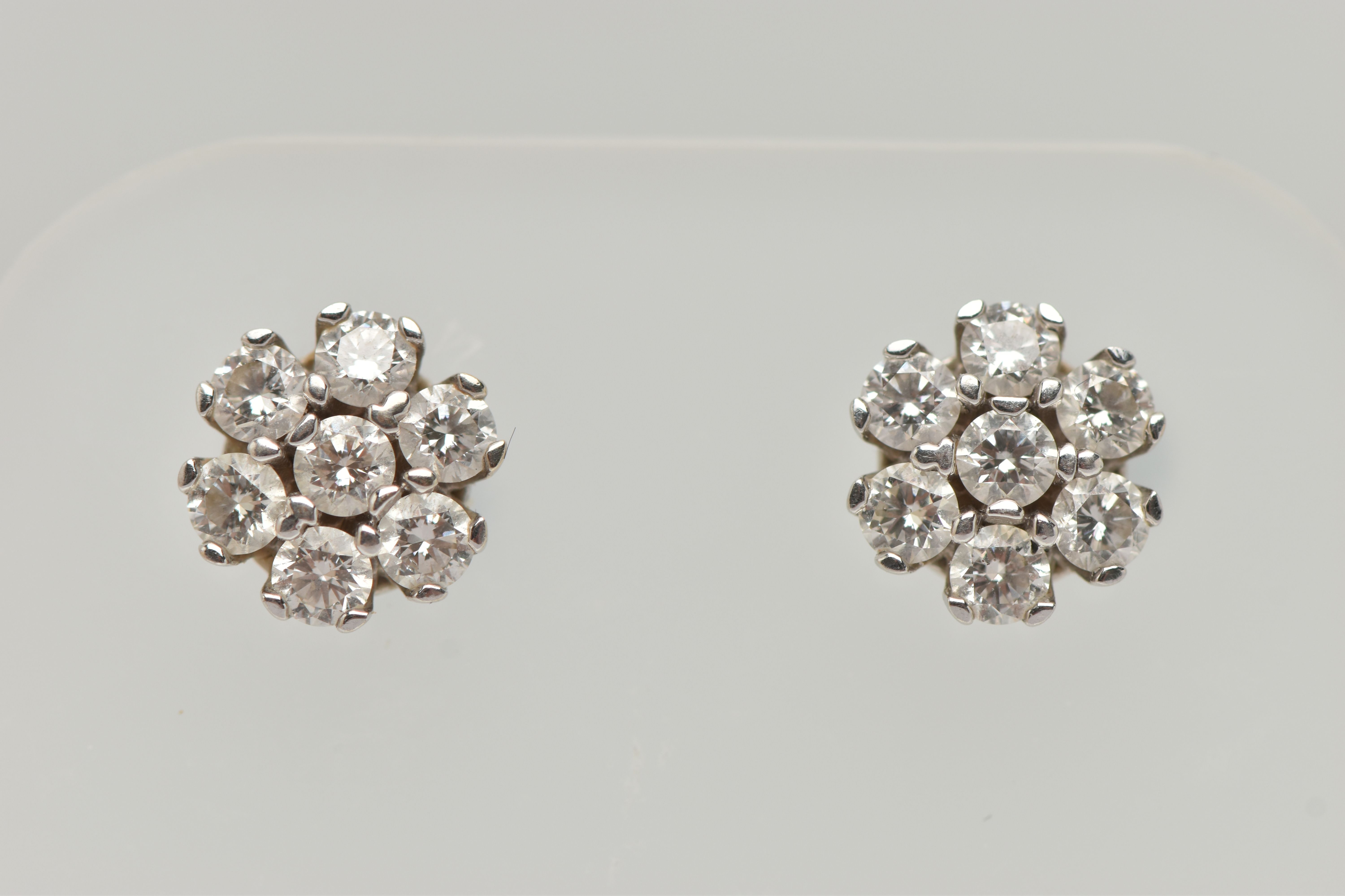 A PAIR OF WHITE METAL DIAMOND CLUSTER EARRINGS, each of a flower shape, set with seven round - Image 4 of 5