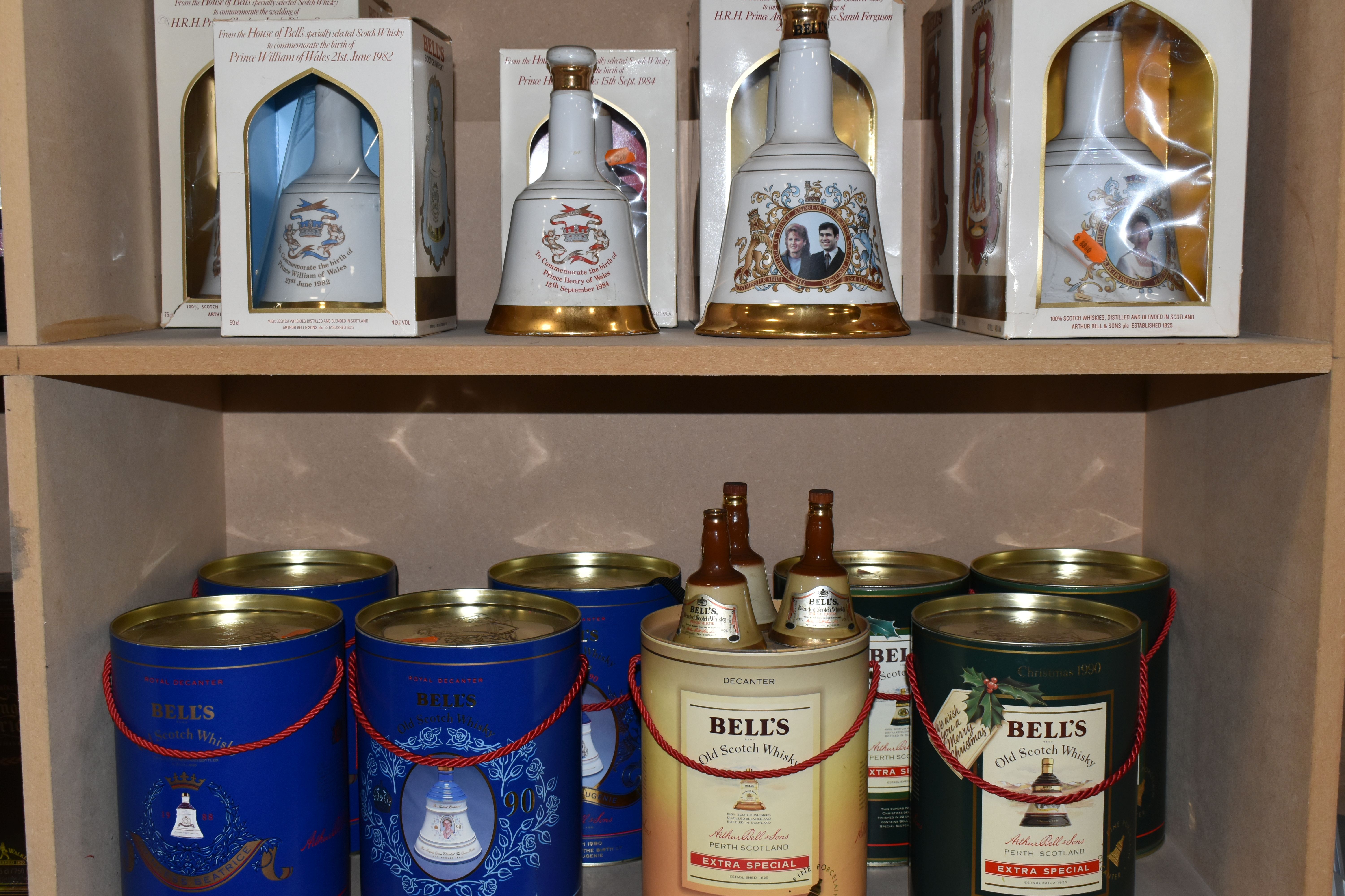 A COLLECTION OF SIXTEEN BELL'S WHISKY, COMMEMORATIVE WADE PORCELAIN DECANTERS, comprising The