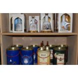 A COLLECTION OF SIXTEEN BELL'S WHISKY, COMMEMORATIVE WADE PORCELAIN DECANTERS, comprising The