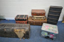A VARIETY OF TRAVELING TRUNKS, to include two wooden banded and canvas trunks, a distressed large