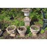 FOUR MODERN COMPOSITE GARDEN URNS AND A SQUARE BASE comprising of a pair of balusters with fluted