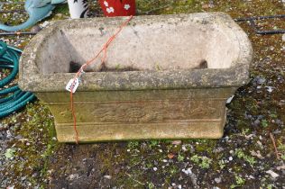 A WEATHERED COMPOSITE GARDEN PLANTER rectangular with flared sides and floral detail length 63cm