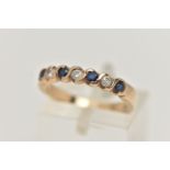 A SAPPHIRE AND DIAMOND SEVEN STONE RING, set with four circular cut sapphires, each measuring