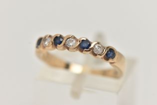 A SAPPHIRE AND DIAMOND SEVEN STONE RING, set with four circular cut sapphires, each measuring