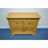 A LIGHT OAK SIDEBOARD, fitted with two drawers above two cupboard doors, width 112cm x depth 48cm