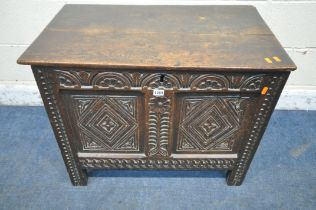 A GEORGIAN OAK COFFER, the hinged lid enclosing a candle box, the front with repeating geometric