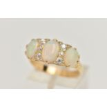 AN EARLY 20TH CENTURY OPAL AND DIAMOND RING, set with graduating oval opal cabochons, measuring from