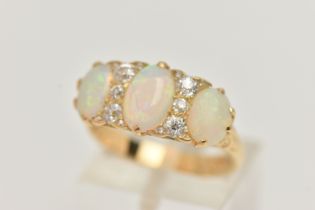 AN EARLY 20TH CENTURY OPAL AND DIAMOND RING, set with graduating oval opal cabochons, measuring from