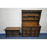 A GRANGEMOOR OAK DRESSER, fitted with two lead glazed doors, a two tier plate rack, atop a base with