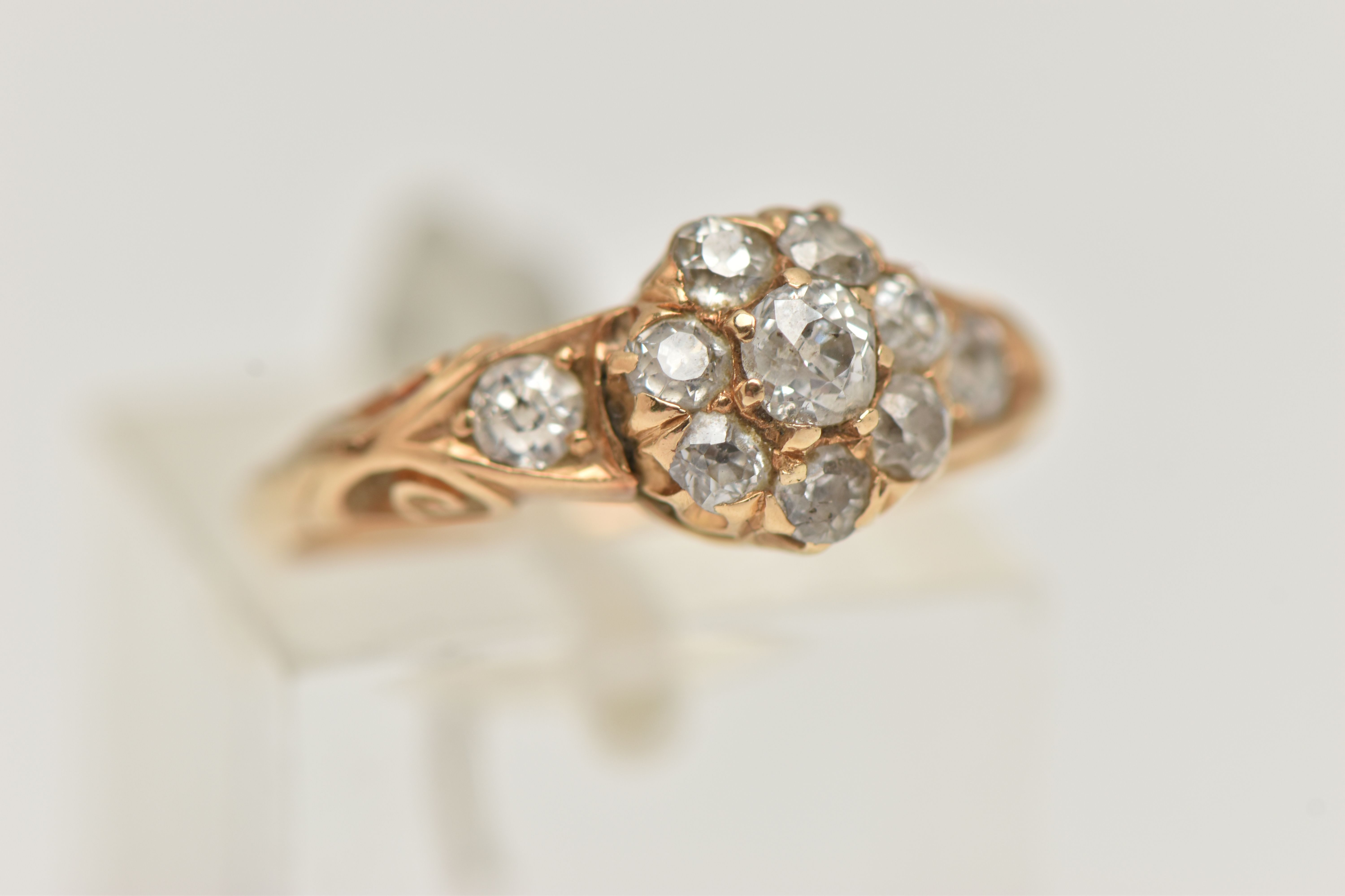 A YELLOW METAL DIAMOND CLUSTER RING, circular cluster set with eight old cut diamonds, flanked - Image 4 of 4