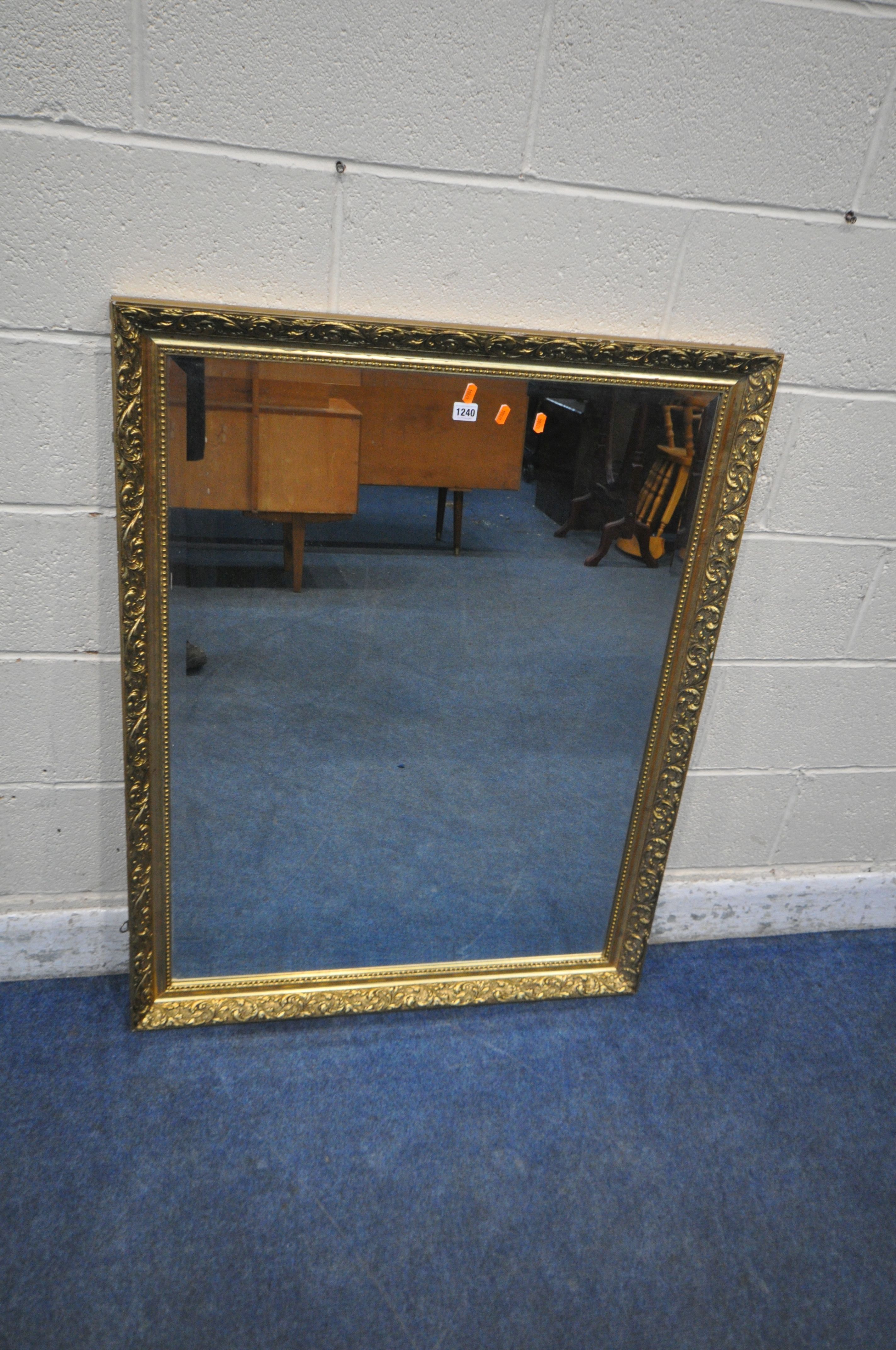 A RECTANGULAR GILT FRAMED BEVELLED EDGE WALL MIRROR, 114cm x 87cm (condition report: some small
