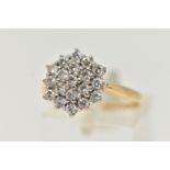 A YELLOW METAL DIAMOND CLUSTER RING, cluster set with round brilliant cut diamonds, estimated