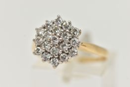 A YELLOW METAL DIAMOND CLUSTER RING, cluster set with round brilliant cut diamonds, estimated