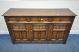 A GOOD QUALITY REPRODUCTION TITCHMARSH AND GOODWIN STYLE OAK SIDEBOARD, fitted with three drawers,