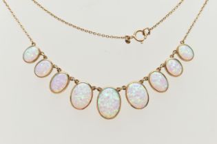 A YELLOW METAL SYNTHETIC OPAL PENDANT NECKLACE, designed as a series of nine graduated synthetic