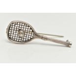 A WHITE METAL BROOCH, in the form of a tennis racket set with a colourless paste imitating a