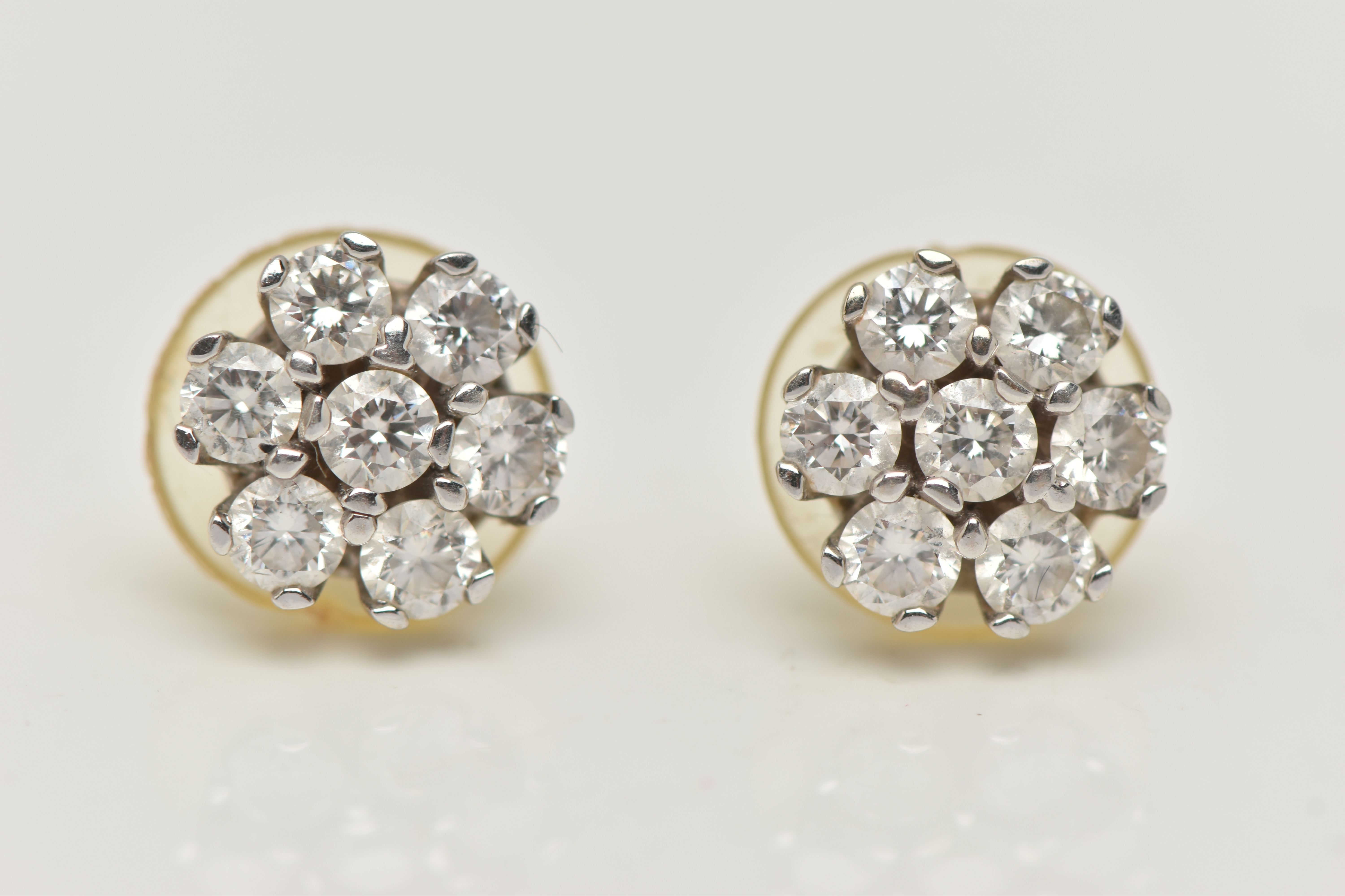 A PAIR OF WHITE METAL DIAMOND CLUSTER EARRINGS, each of a flower shape, set with seven round - Image 2 of 5