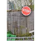 A WROUGHT IRON DOOMED GATE width 81cm height 194cm and a modern Stop and Go road sign (condition