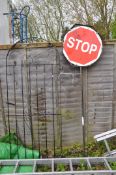 A WROUGHT IRON DOOMED GATE width 81cm height 194cm and a modern Stop and Go road sign (condition