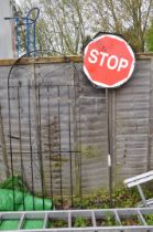 A WROUGHT IRON DOOMED GATE width 81cm height 194cm and a modern Stop and Go road sign (condition