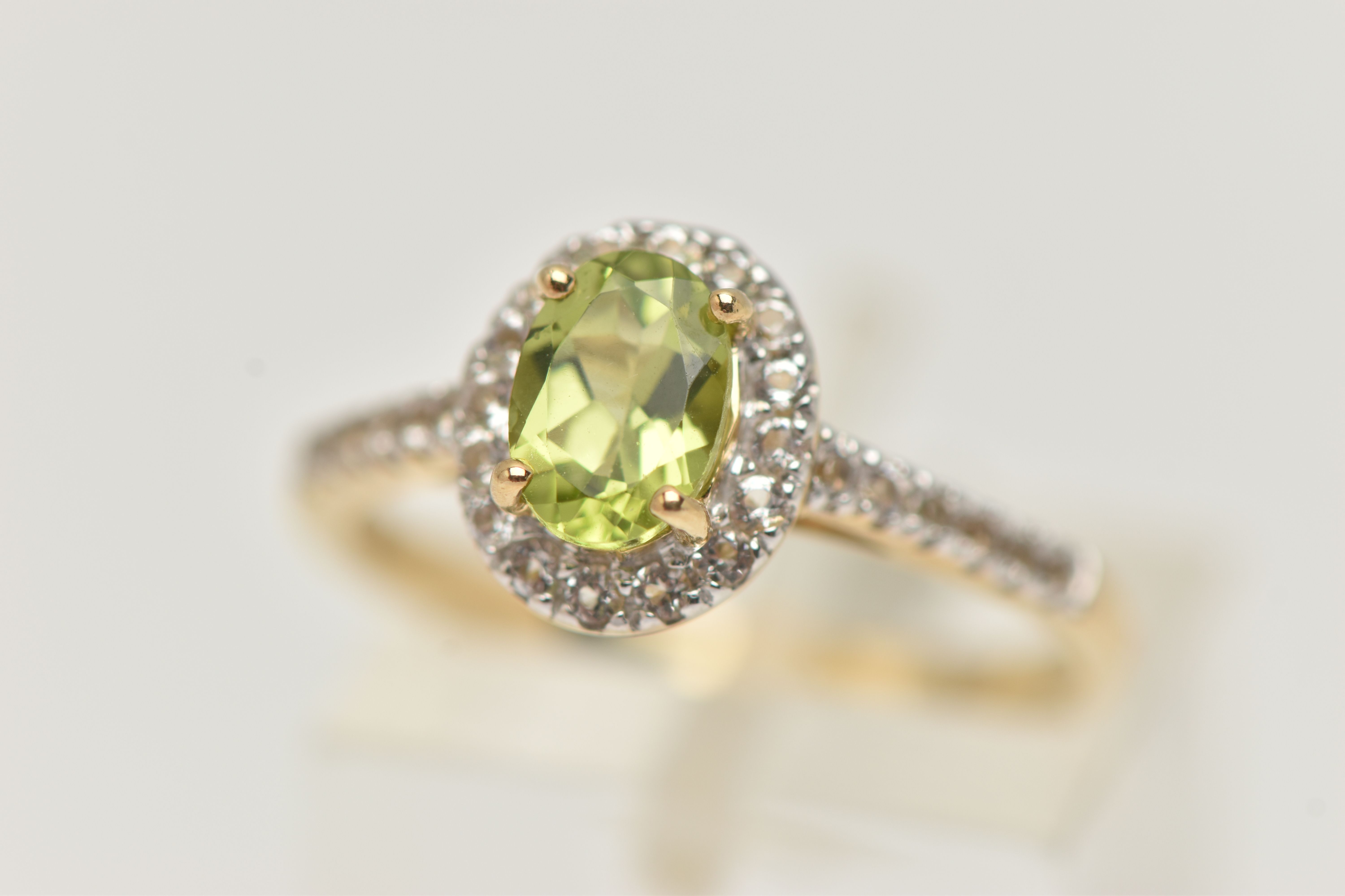 A 9CT GOLD PERIDOT DRESS RING, a principally set oval cut peridot, prong set in yellow gold, set