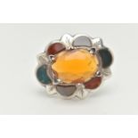 A WHITE METAL HARDSTONE SCOTTISH BROOCH, of an oval wavy form, set with a large oval cut orange
