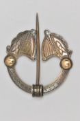 AN IRISH SILVER PENANNULAR CELTIC BROOCH, designed as two harps with yellow metal embellishments,