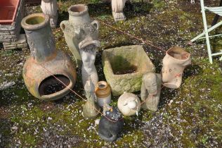 A COLLECTION OF WEATHERED GARDEN POTS AND ORNAMENTS including a chiminea top, an urn, figures of a