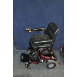 A ROMA ELECTRIC WHEEL CHAIR in red (SPARES OR REPAIRS) with battery and charger (doesn't appear to