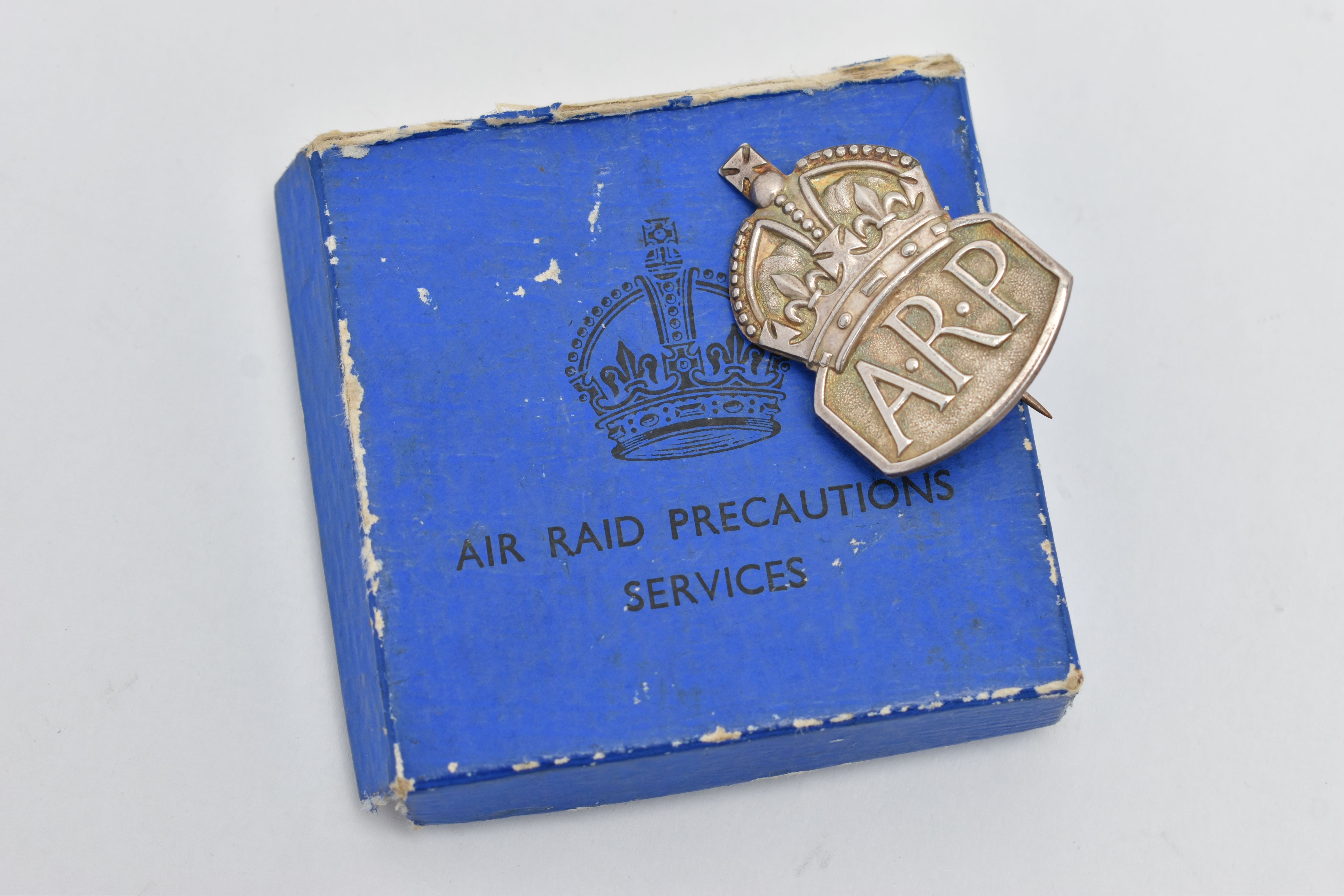 A SILVER 'A.R.P' BADGE, hallmarked 'Royal Mint' London 1938, fitted with pin and C clasp,