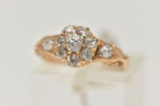 A YELLOW METAL DIAMOND CLUSTER RING, circular cluster set with eight old cut diamonds, flanked