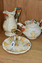 THREE PIECES OF CLARICE CLIFF 'CELTIC HARVEST' PATTERN TEA WARE, comprising a single tier cake