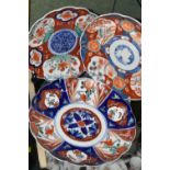 THREE LATE 19TH CENTURY JAPANESE IMARI PLATES, all with wavy rims, varying designs with flora and
